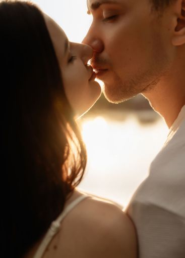 Romantic Sunset Kiss A Couple Captured in a Tender...