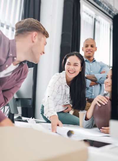 happy young business people laughing while working...