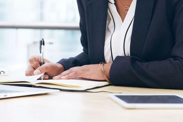 Notebook, planning and research with hands of employee...