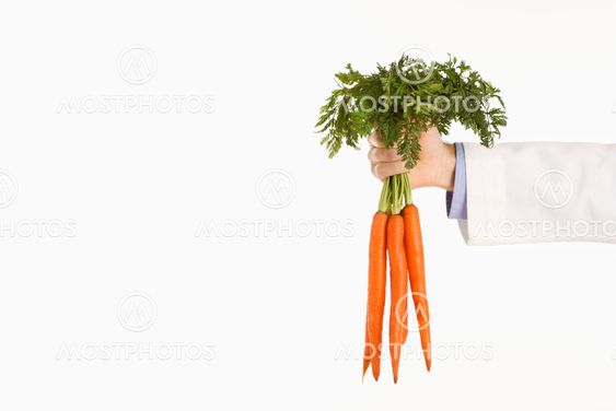 Doctor holding carrots.