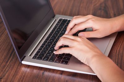 Close-up of hand using laptop