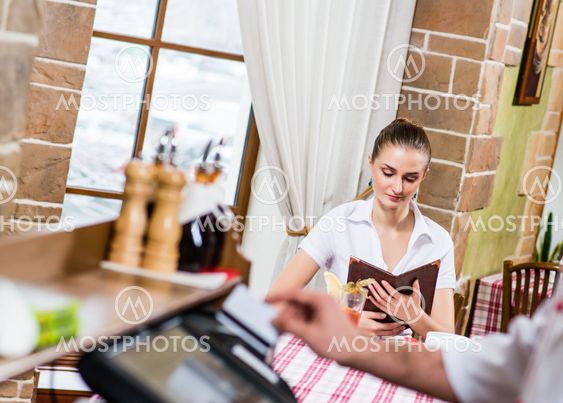 waiter inserts the card into a computer terminal