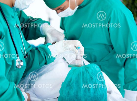 Medical team using equipment on the patient