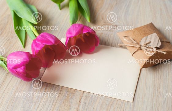 Three purple tulips and space for text