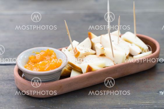 Spiced cheeseboard with sea buckthorns jam in crockery