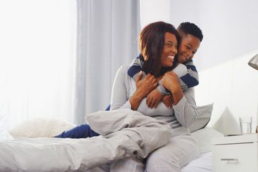 Home, mother and son in bedroom, hug and bonding...