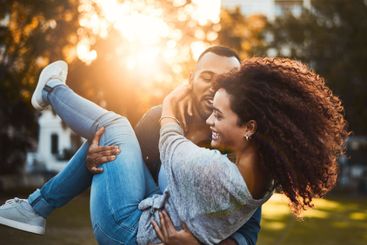 Carry, playful and couple with fun at park for sunset...