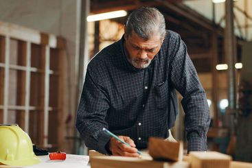Industry, woodwork and writing with carpenter man in...