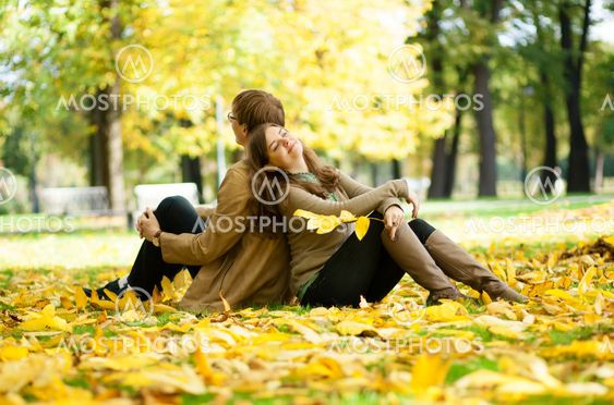 Dating couple in yellow leaves on a fall day