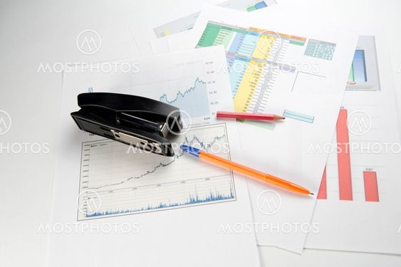 Business background with pen, pencil and stapler