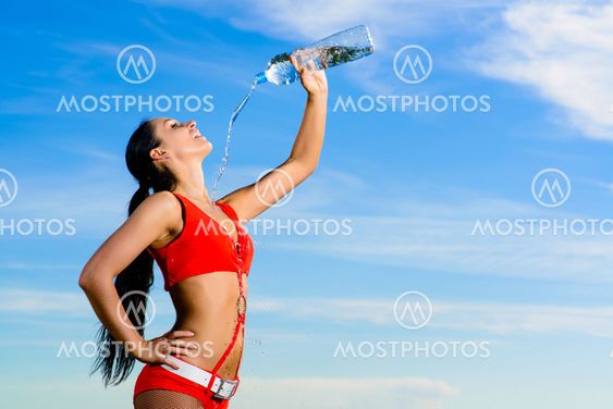 sport girl in red uniform with a bottle of water