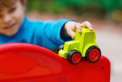 Little toddler boy playing with car toy