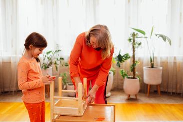Elderly woman in casual clothes and her little...