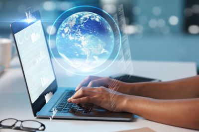 Laptop, hands and globe hologram, future technology and...