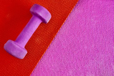 Fitness, dumbbell and weightlifting on colourful...