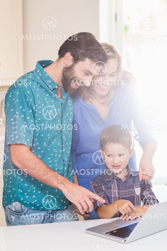 Happy parents and son using laptop