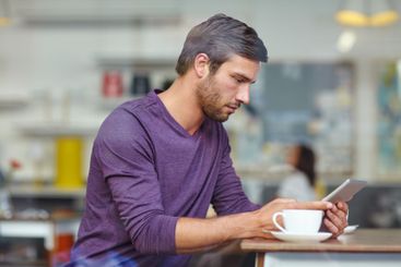 Cafe, coffee and man with tablet for remote work,...