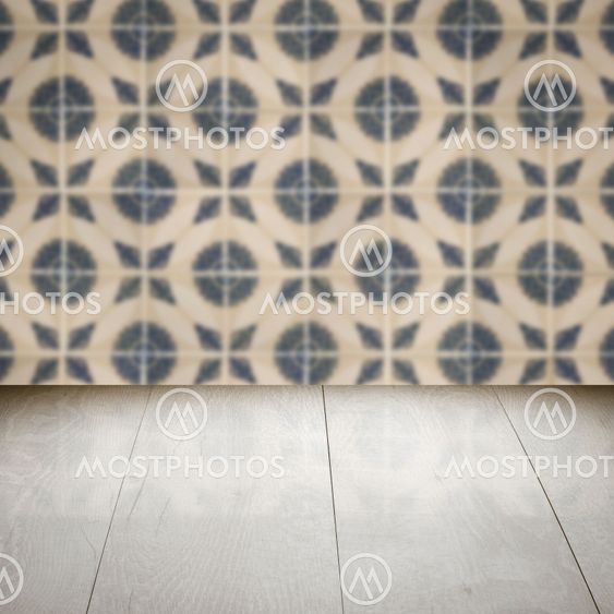 Wood table top and blur vintage ceramic tile pattern wall
