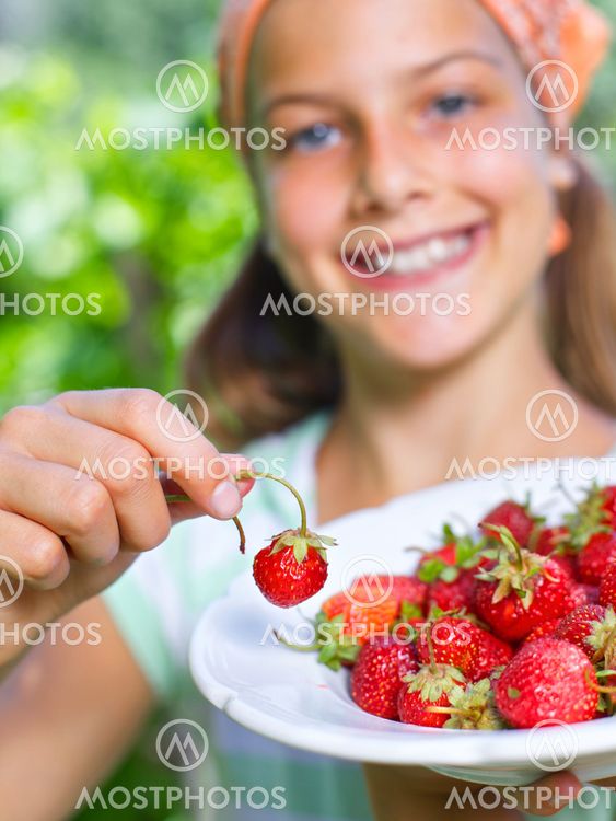 Girl eating strawberries