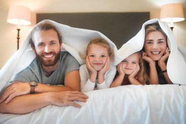 Happy family, portrait and blanket on bed for relax,...