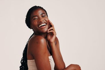 Skincare, health and black woman in studio with natural,...