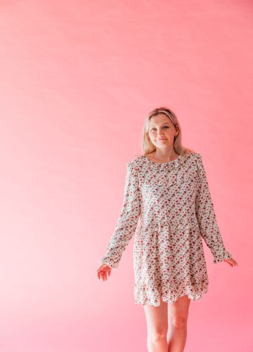 Beautiful blonde woman in summer dress smiling on pink...