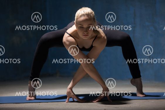 Beautiful Yoga Woman standing in Forward Bending Squat