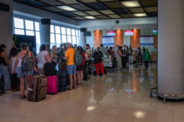 A busy airport checkin line filled with various...