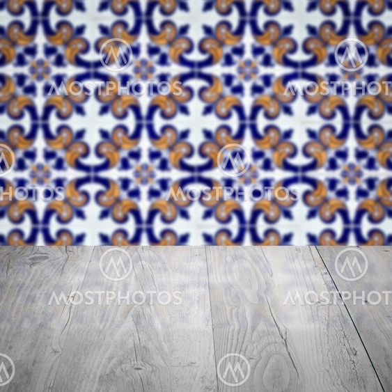 Wood table top and blur vintage ceramic tile pattern wall