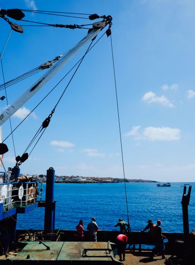 sailors waiting to off load the goods in the beautiful...