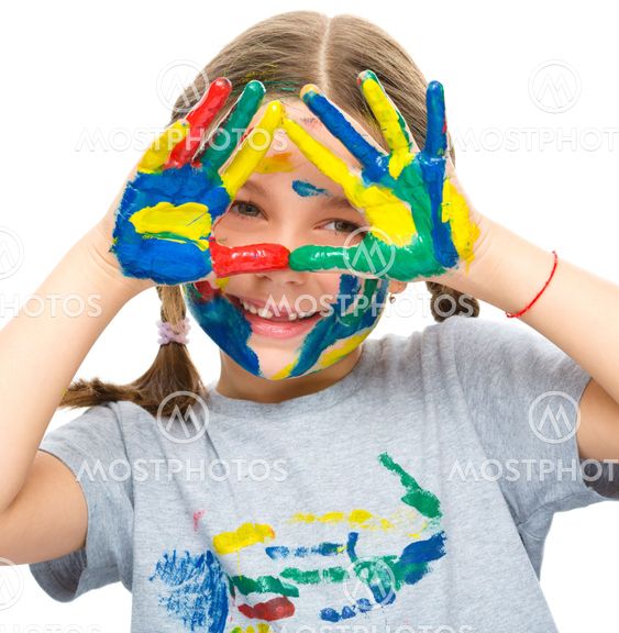 Portrait of a cute girl playing with paints