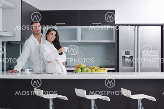 young couple have fun in modern kitchen