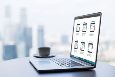 laptop with smartphone interface design on screen