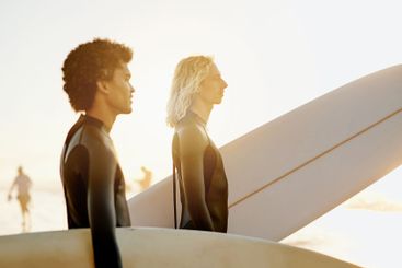 Men profile, surfer and friends by the sea with sunset...