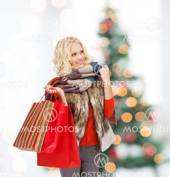 teenage girl in winter clothes with shopping bags