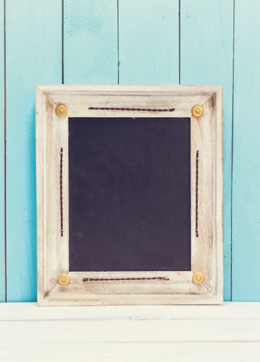 Cozy pastel wooden home decor objects on blue background