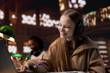 Female student takes notes while she participates at the...