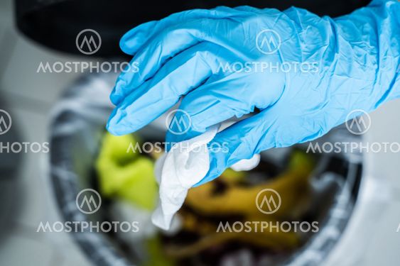 Throwing Away Dirty Sanitizing Wipe