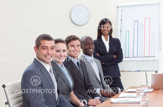 Businesswoman reporting to sales figures to her colleagues