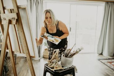 Artist, creativity and painting, woman in living room at...