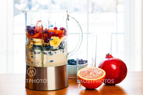 Preparing smoothies with fruit and yogurt