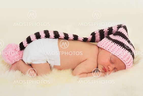 infant sleeping in the white sheep's clothing.
