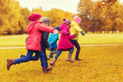 group of happy little kids running outdoors