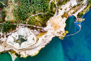 aerial shoot of a lake coast with sand mining