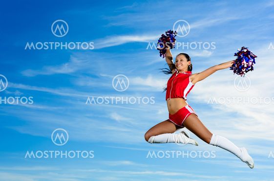 Young cheerleader in red costume jumping