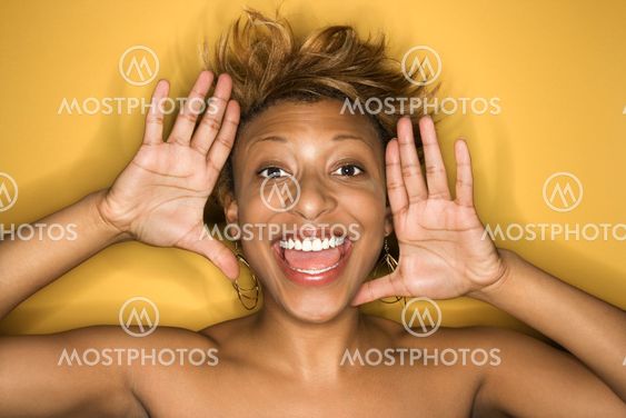 Woman framing smiling face.