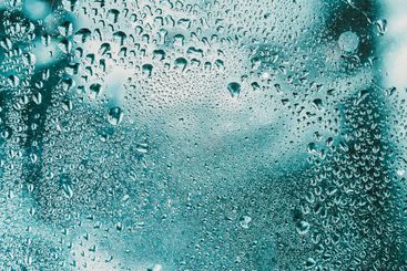 Drops Of Water Or Rain On Wet Glass Background. Moody...