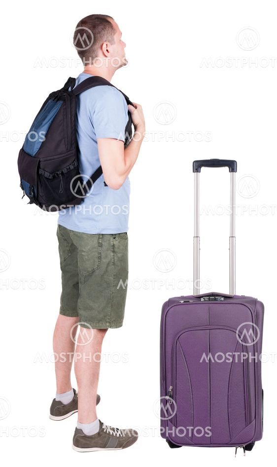 Back view of young man traveling with suitcas.