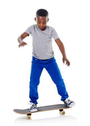 Studio, trick and boy with skateboard for riding,...