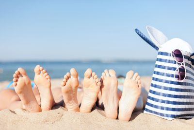 three women lying on the beach